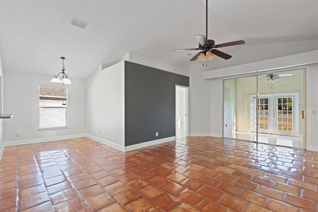 1533 Sunset View Circle Apopka, FL 32703 - Photo 7 of 23 a view of a room with a chandelier fan and windows