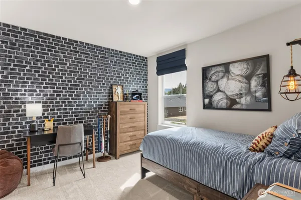 a bedroom with a bed and wall painting
