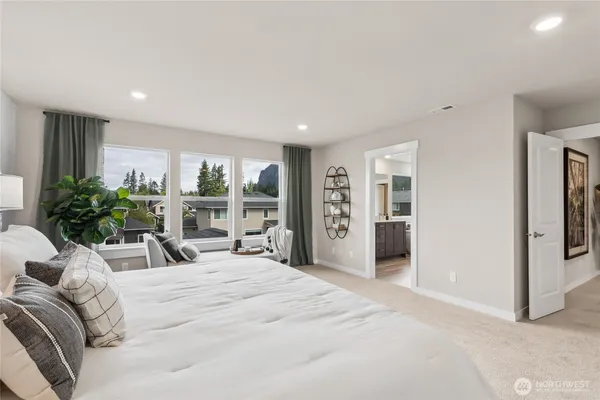 a bedroom with a large bed and a large window