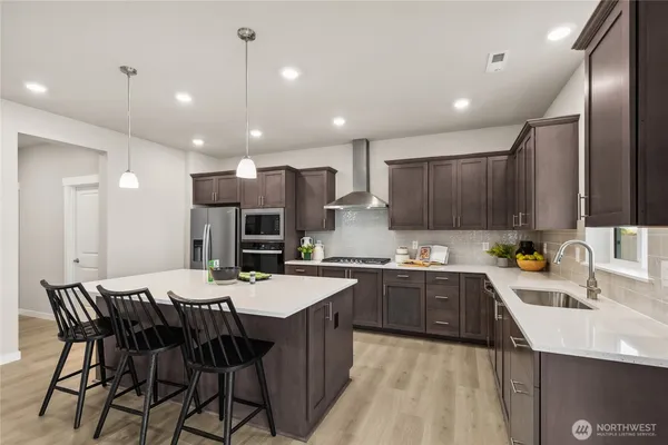 a large kitchen with a table and chairs