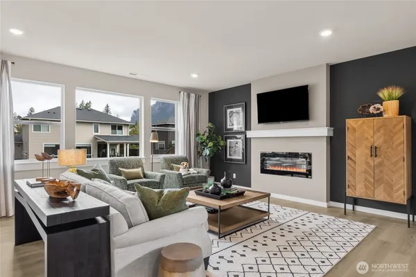 a living room with furniture a flat screen tv and a fireplace