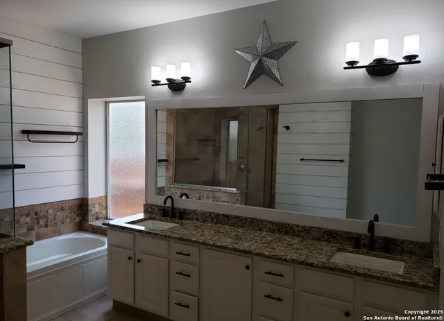 a bathroom with a double vanity sink and a mirror