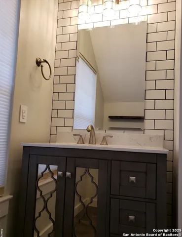 a bathroom with a sink and a mirror