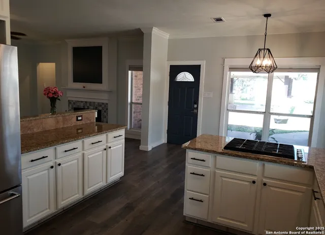 a view of a patio with table and chairs a barbeque with wooden fence