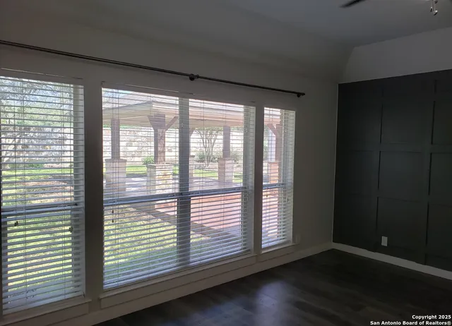 a view of wooden floor and windows in a room