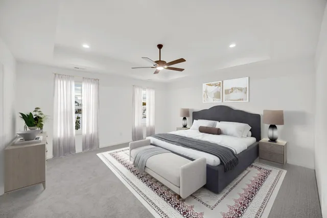 a bedroom with a large bed and a chandelier