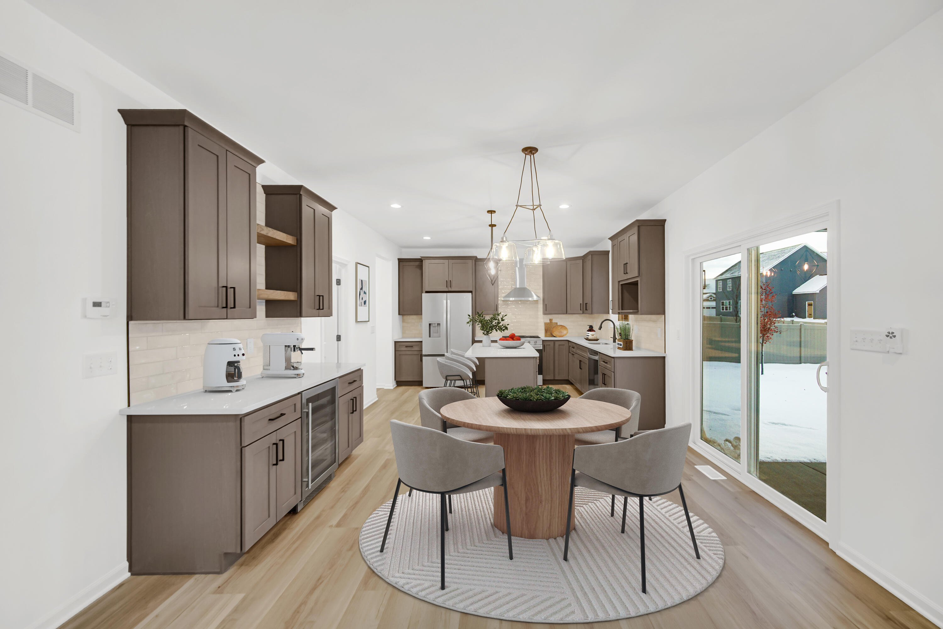 716 Verdano Terrace Crown Point, IN 46307 - Photo 6 of 26 a kitchen with a dining table chairs and white cabinets