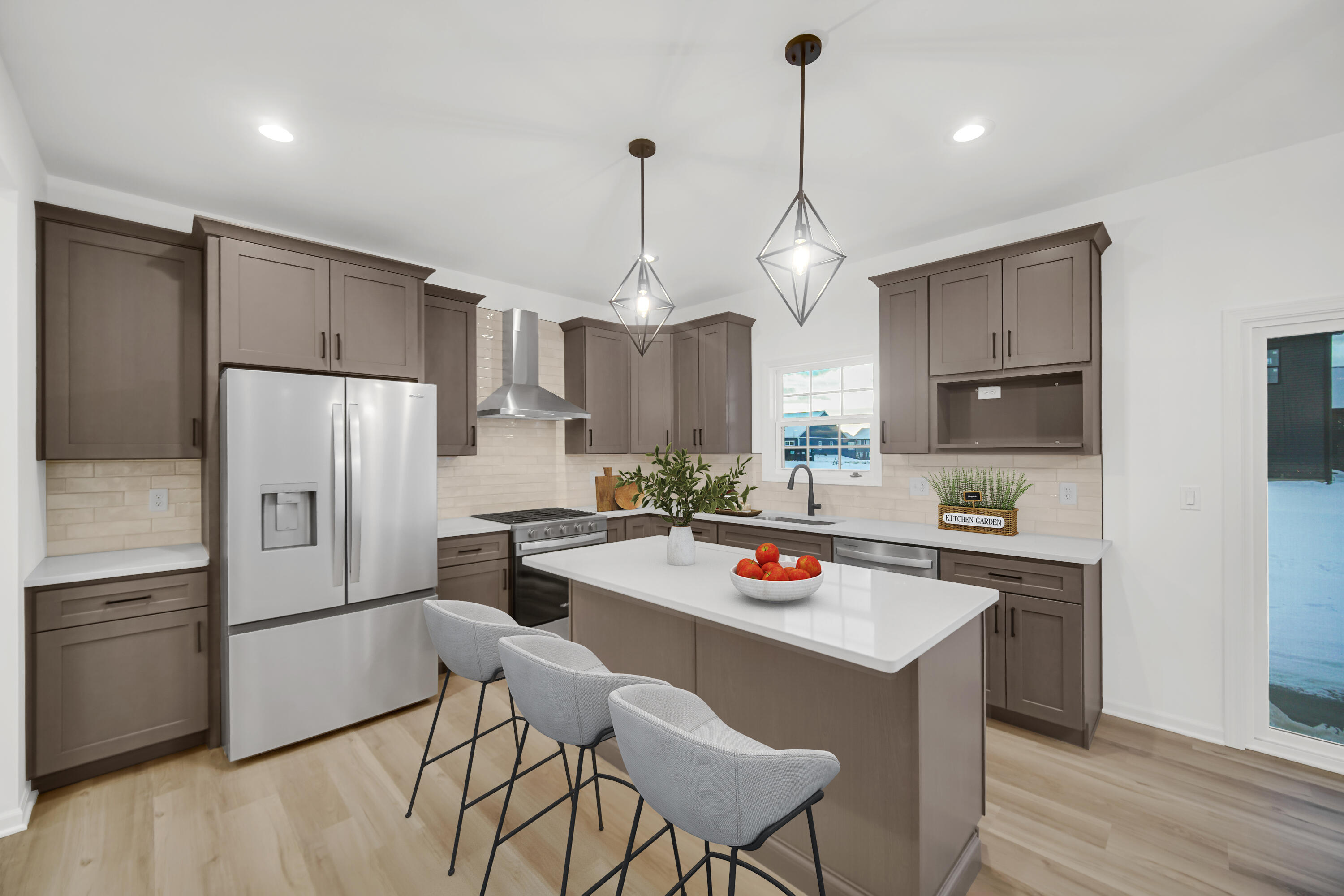 716 Verdano Terrace Crown Point, IN 46307 - Photo 7 of 26 a kitchen with stainless steel appliances granite countertop a refrigerator a sink dishwasher a stove and a dining table with wooden floor