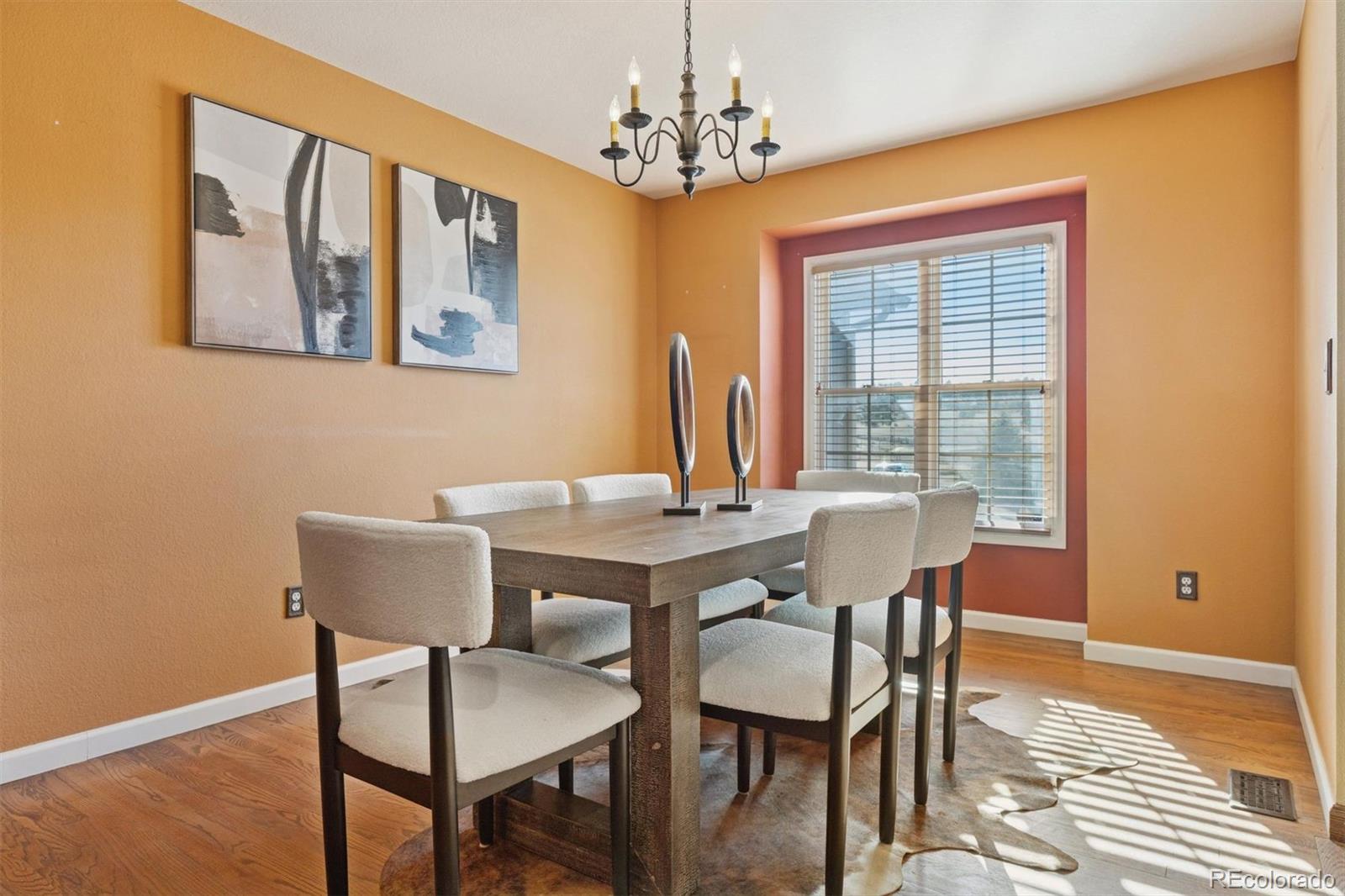 3779 Pasture Gate Circle Elizabeth, CO 80107 - Photo 17 of 49 a view of a dining room with furniture window and wooden floor