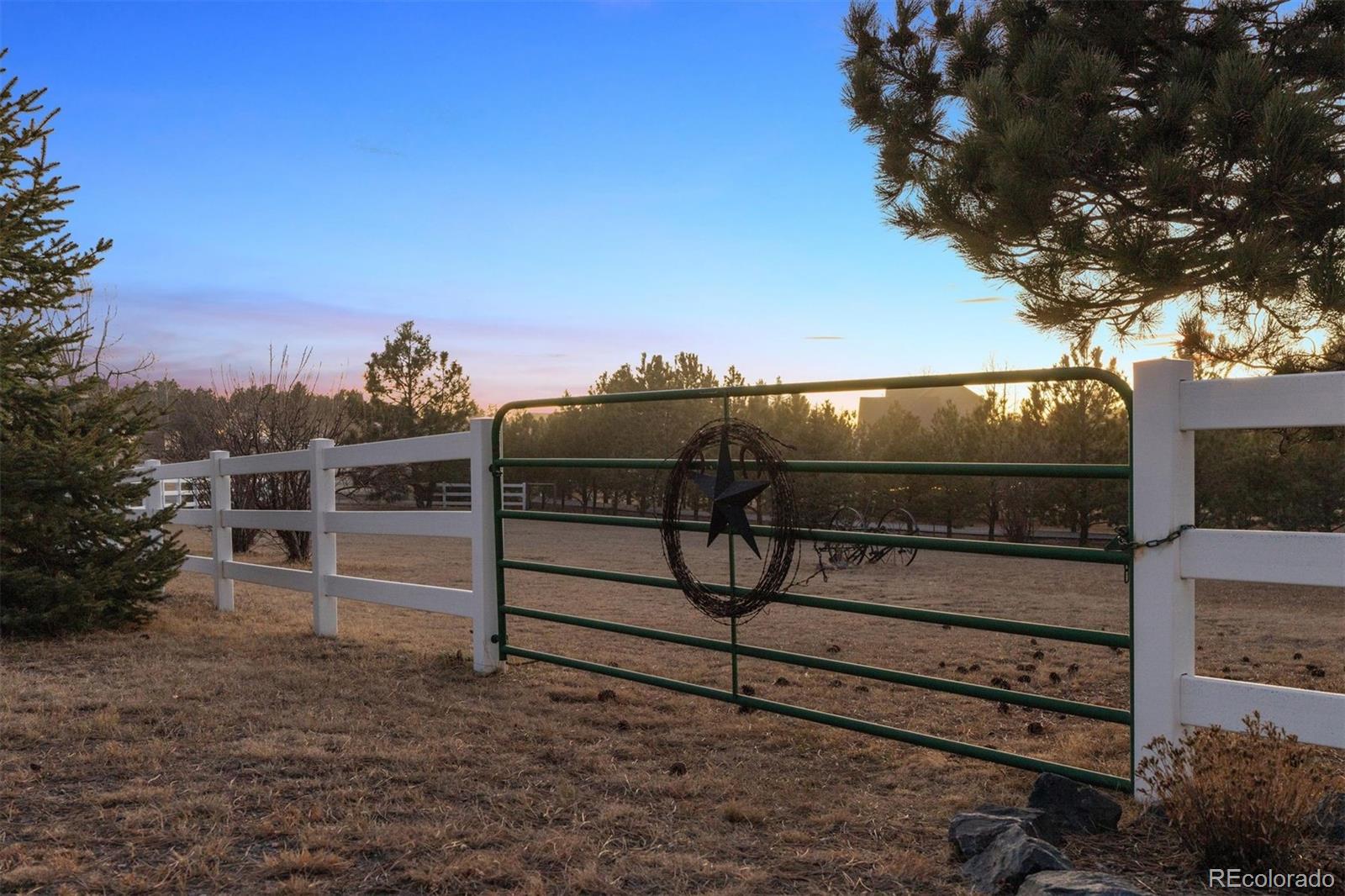 3779 Pasture Gate Circle Elizabeth, CO 80107 - Photo 2 of 49 a view of a wooden fence with a bench in front of house
