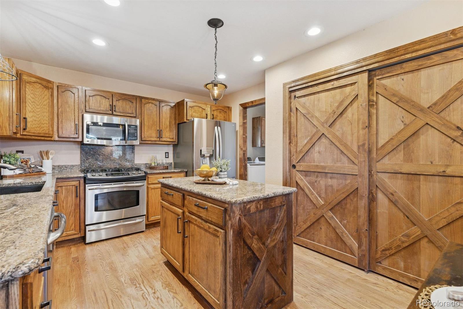 3779 Pasture Gate Circle Elizabeth, CO 80107 - Photo 26 of 49 a kitchen with a stove a sink and a refrigerator