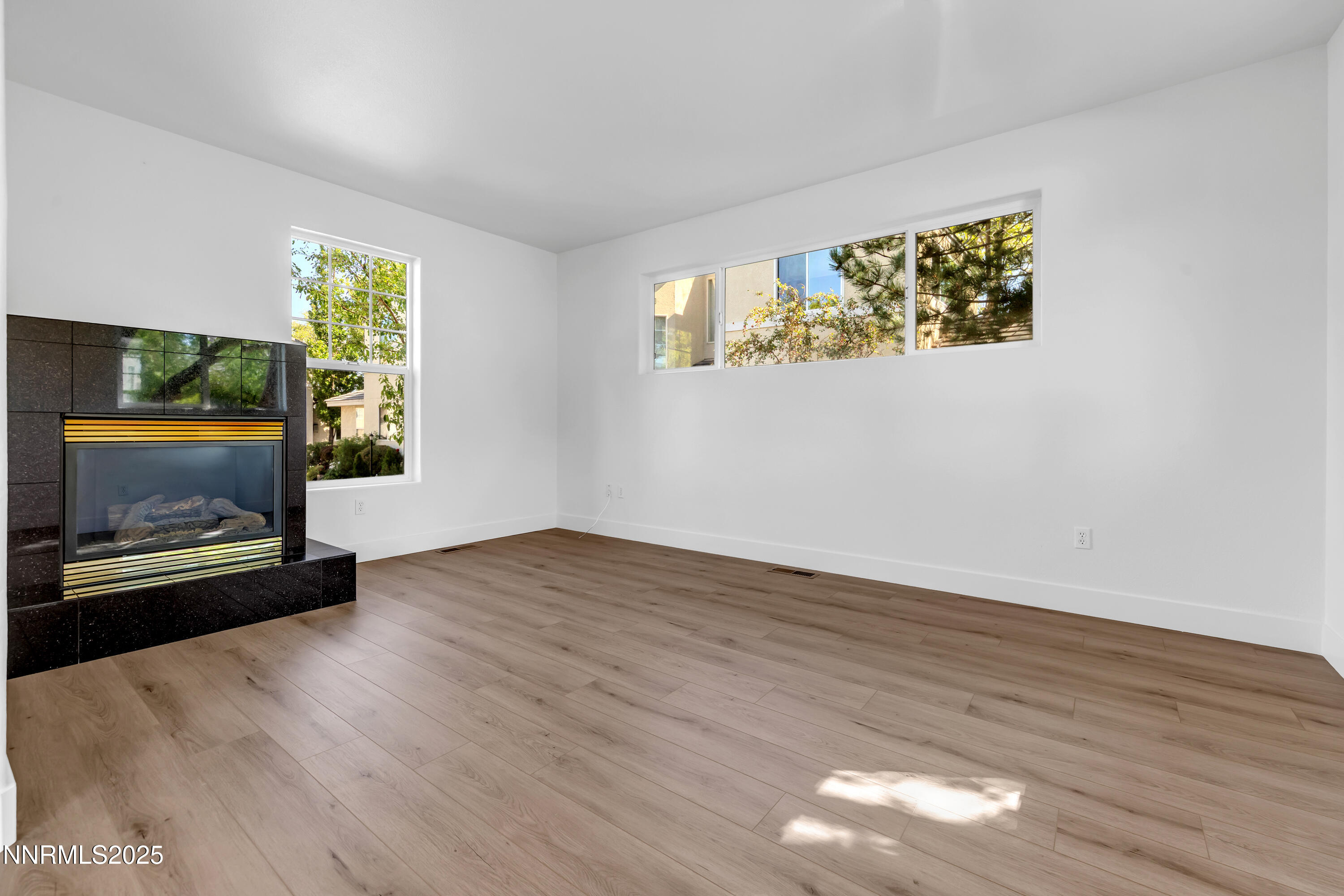 520 Warren Court Reno, NV 89509 - Photo 18 of 42 a view of an empty room with wooden floor and a window