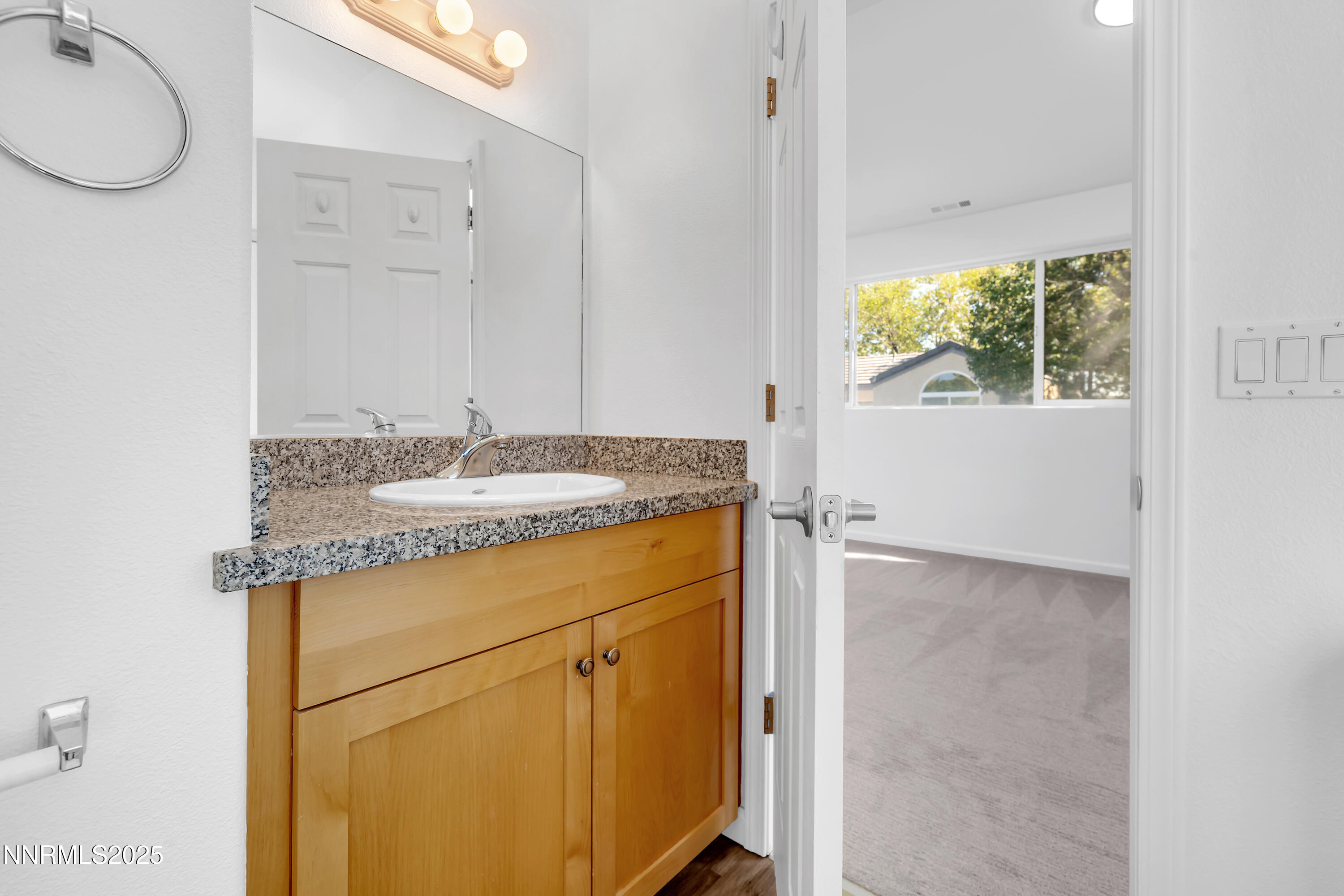 520 Warren Court Reno, NV 89509 - Photo 37 of 42 a bathroom with a granite countertop sink and a mirror