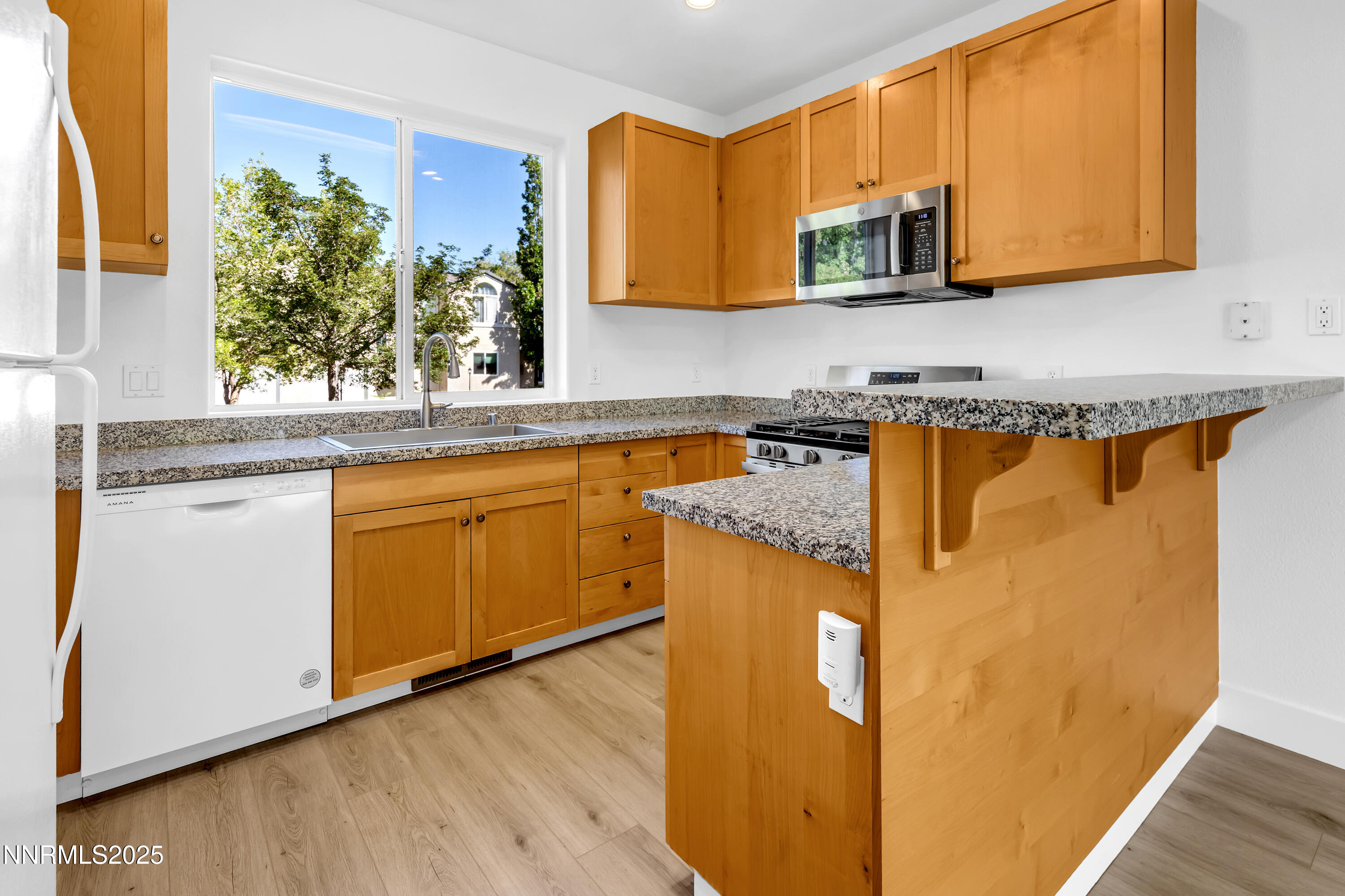 520 Warren Court Reno, NV 89509 - Photo 10 of 42 a kitchen with stainless steel appliances granite countertop a sink and cabinets with wooden floor