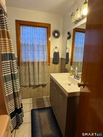 a living room with furniture and a flat screen tv with wooden floor