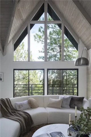 a bedroom with furniture and a large window