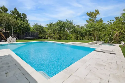 a view of a swimming pool with an outdoor space and seating area