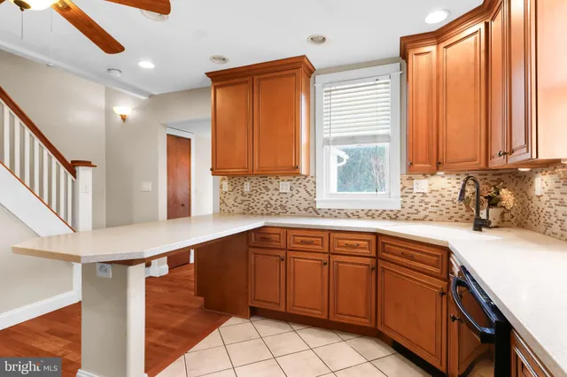 a kitchen with a sink cabinets and window
