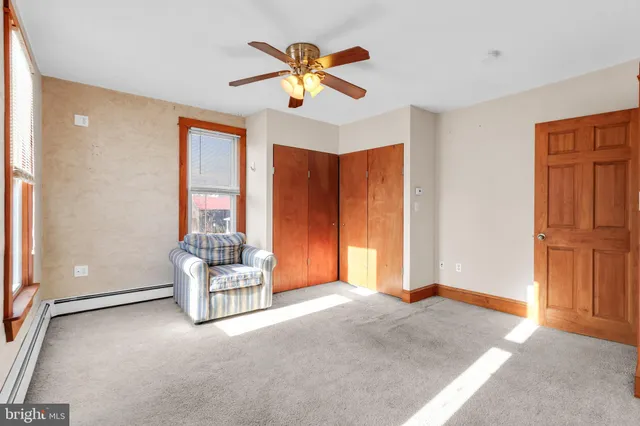 a living room with furniture and ceiling window