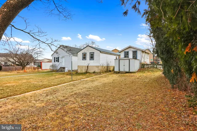 a view of a large house with a big yard and large tree