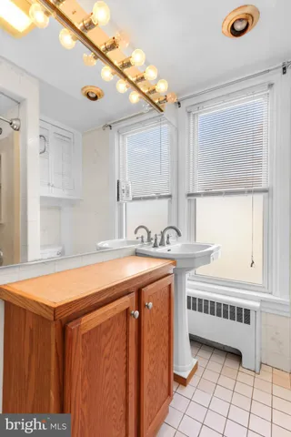a utility room with stainless steel appliances a sink and a window