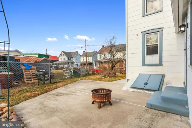 a swimming pool with outdoor seating and yard