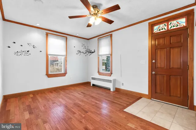 wooden floor in an empty room with a window