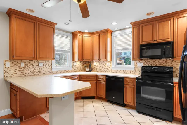 a kitchen with stainless steel appliances granite countertop a sink stove and microwave