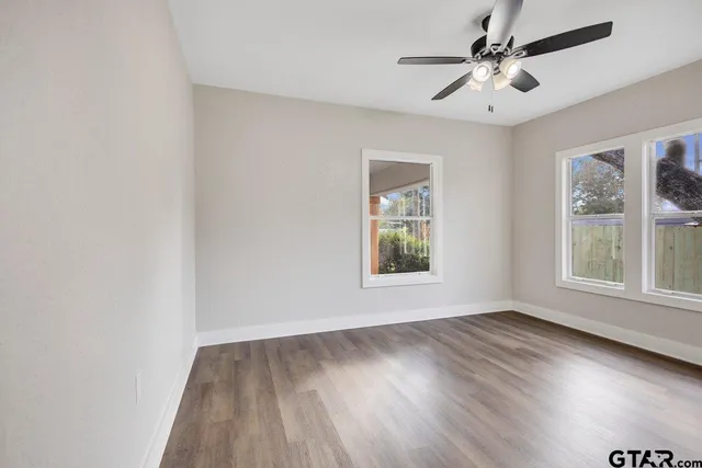 wooden floor in an empty room with a window