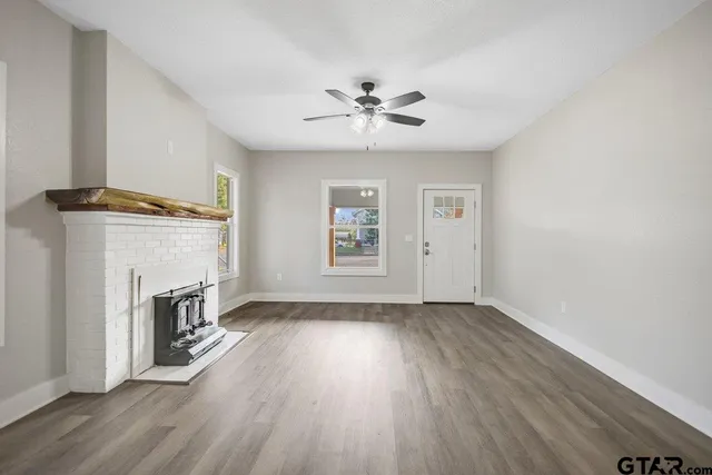 wooden floor in an empty room with a window