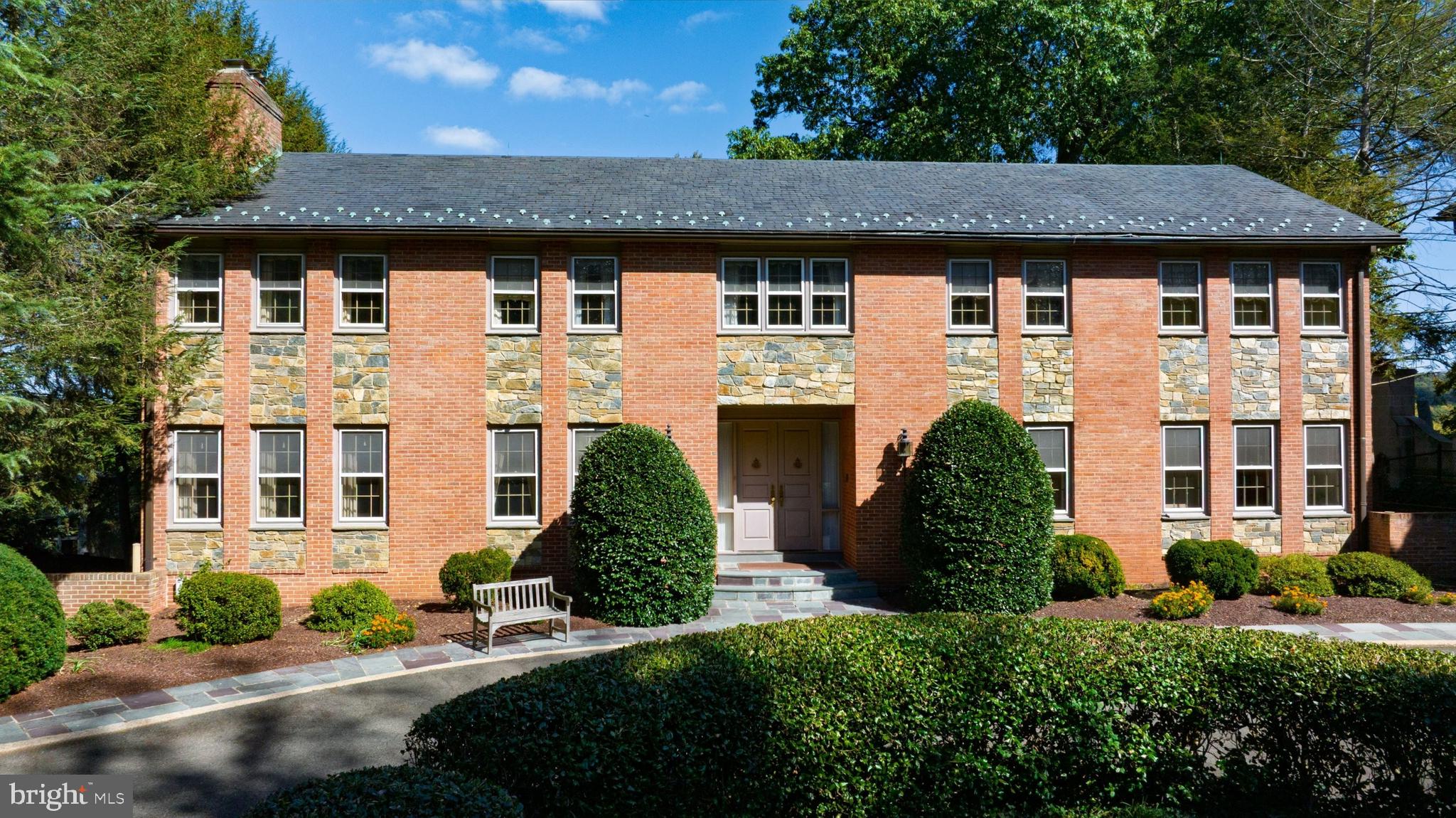 221 Chain Bridge Road McLean, VA 22101 - Photo 5 of 18 a front view of a house with a garden
