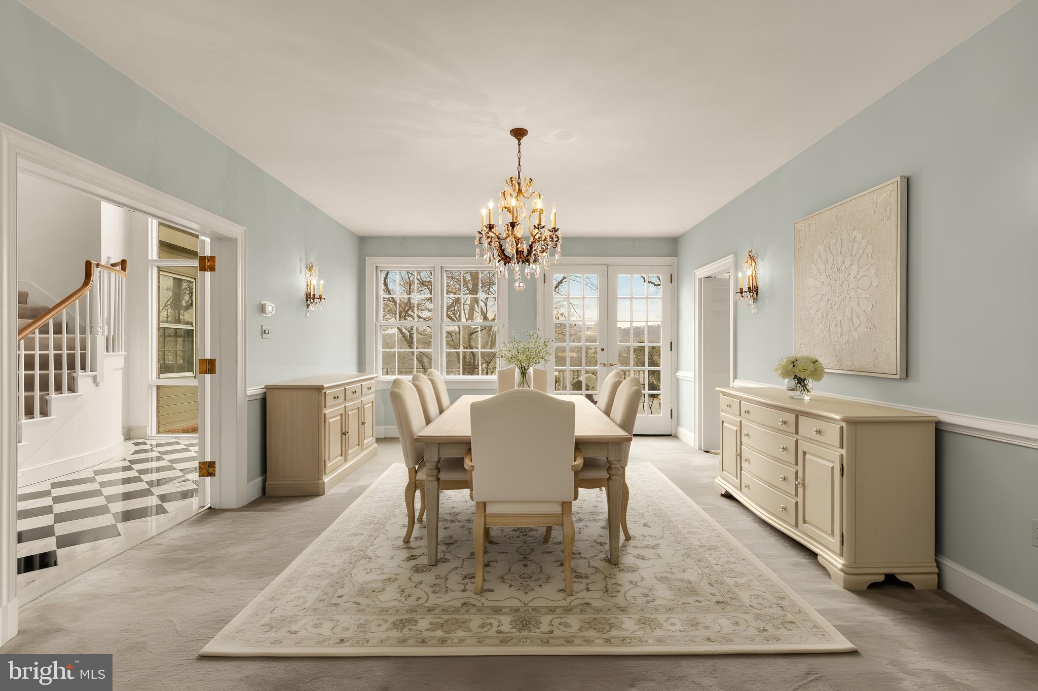 221 Chain Bridge Road McLean, VA 22101 - Photo 9 of 18 a dining room with wooden floor a chandelier a wooden table and chairs