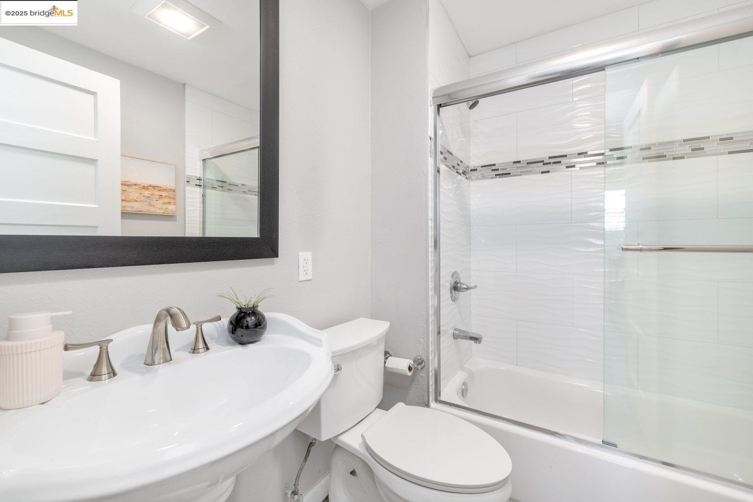 1837 7th Avenue Oakland, CA 94606 - Photo 16 of 42 a bathroom with a sink toilet and shower