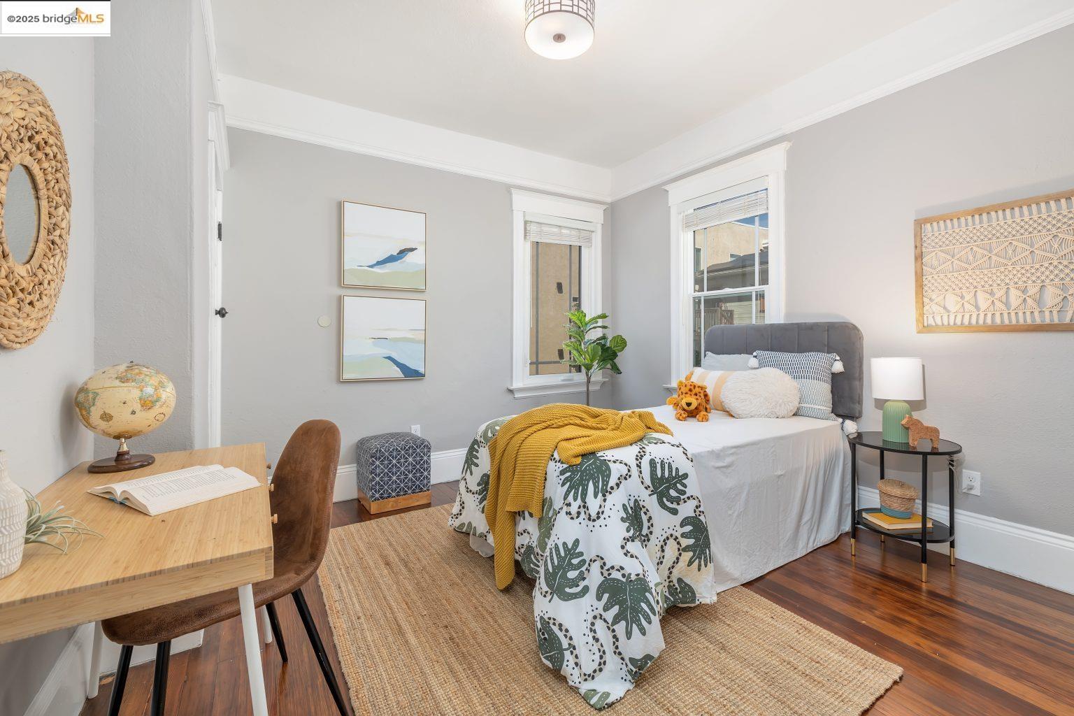 1837 7th Avenue Oakland, CA 94606 - Photo 18 of 42 a bedroom with a bed and wooden floor