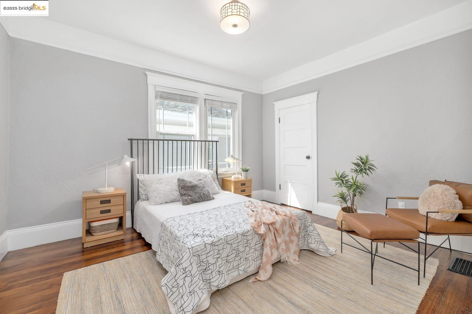 1837 7th Avenue Oakland, CA 94606 - Photo 20 of 42 a bedroom with a bed and a potted plant on table