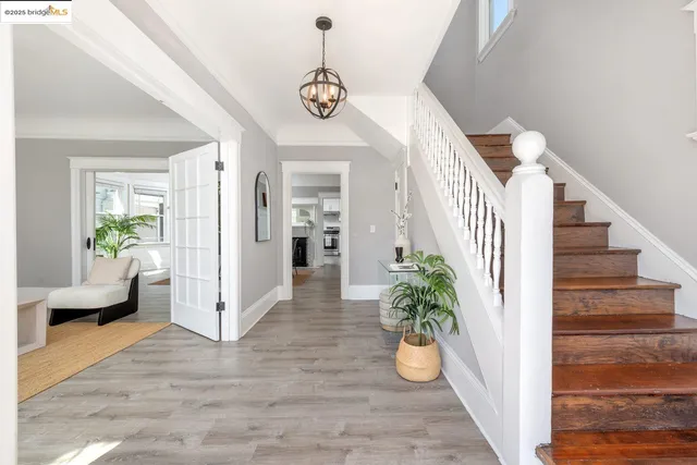 a view of entryway and hall with wooden floor