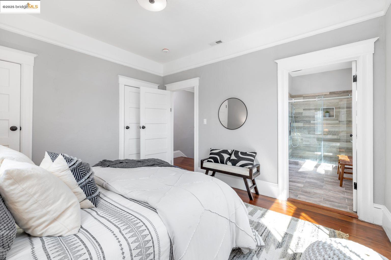 1837 7th Avenue Oakland, CA 94606 - Photo 24 of 42 a bedroom with a bed and wooden floor