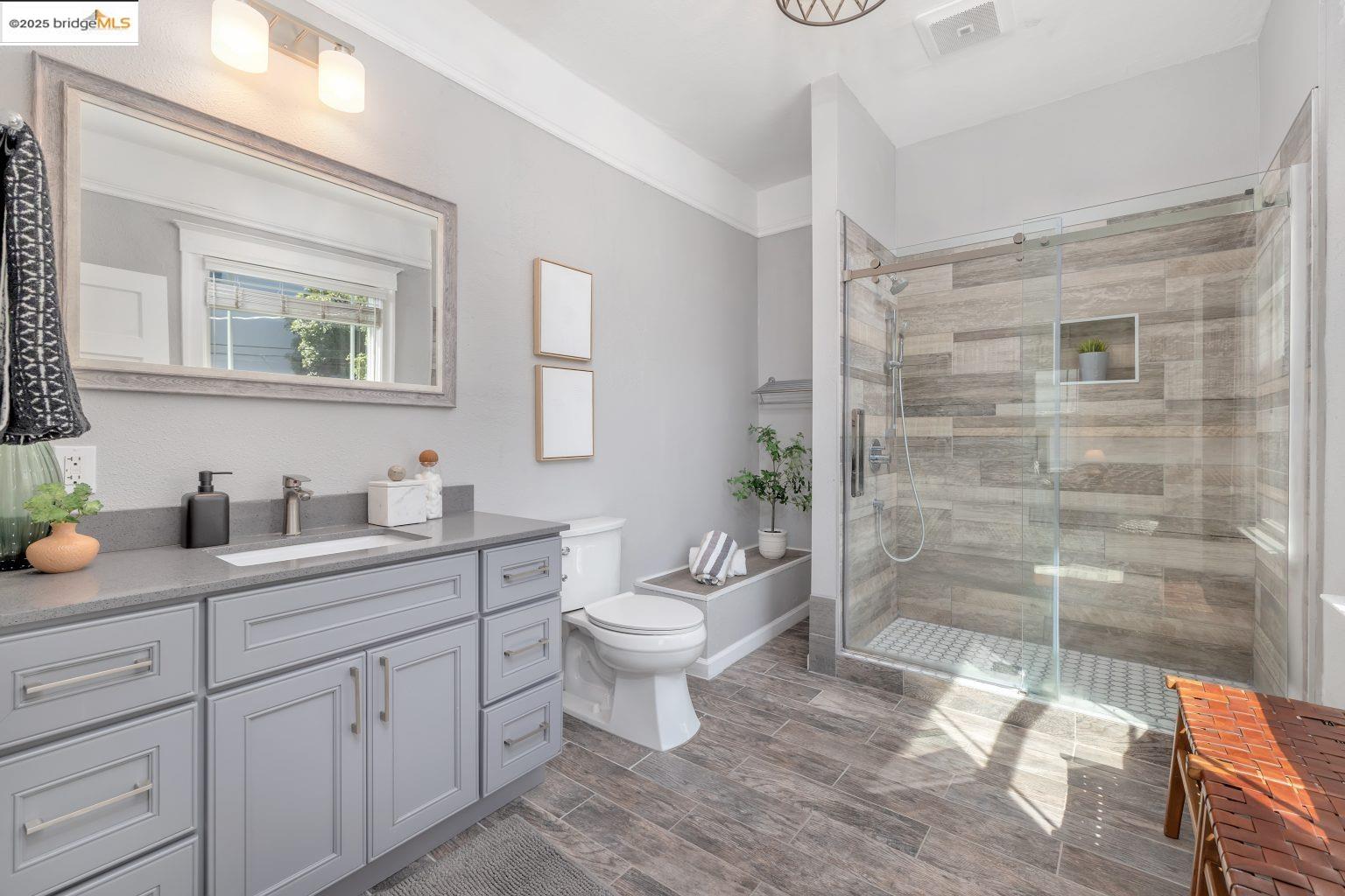 1837 7th Avenue Oakland, CA 94606 - Photo 26 of 42 a bathroom with a granite countertop toilet sink and mirror