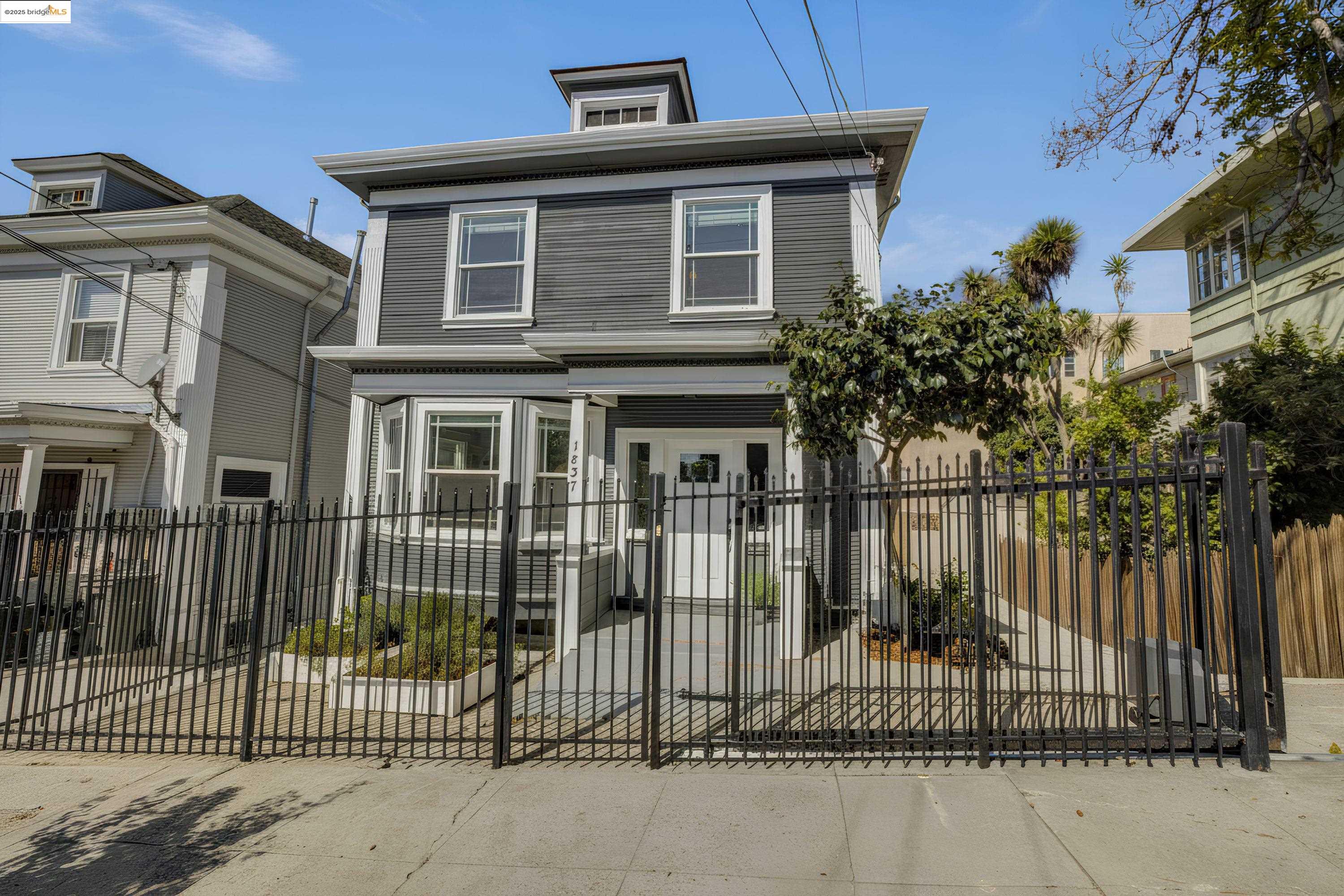 1837 7th Avenue Oakland, CA 94606 - Photo 30 of 42 a front view of a house with a iron gate