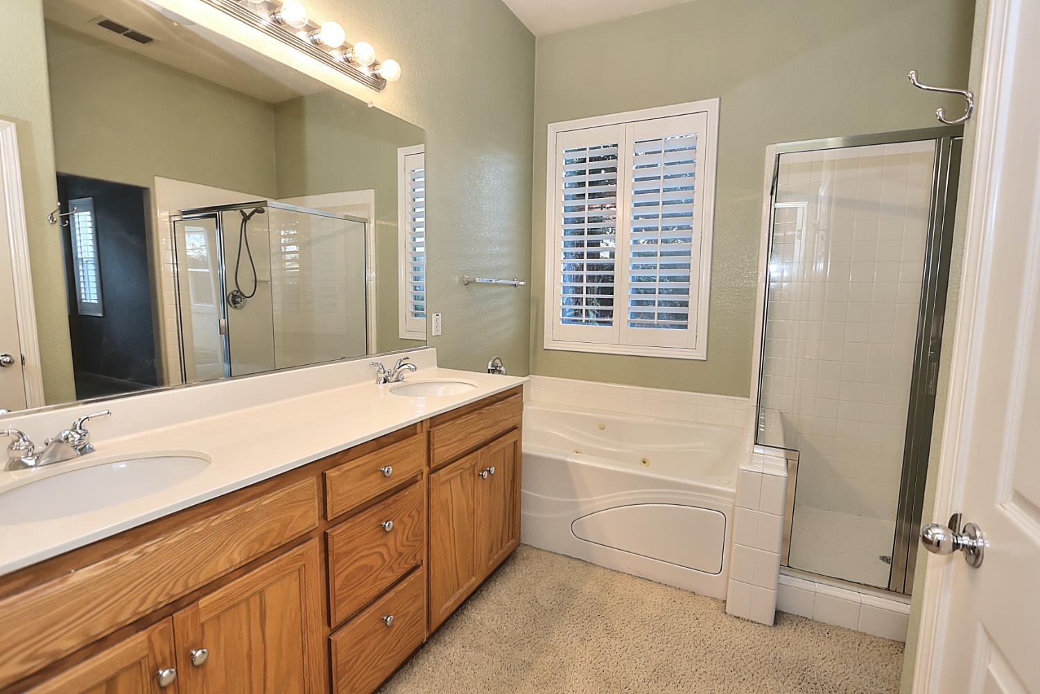 331 Unity Circle Sacramento, CA 95833 - Photo 44 of 77 a spacious bathroom with a double vanity sink a mirror and a bathtub