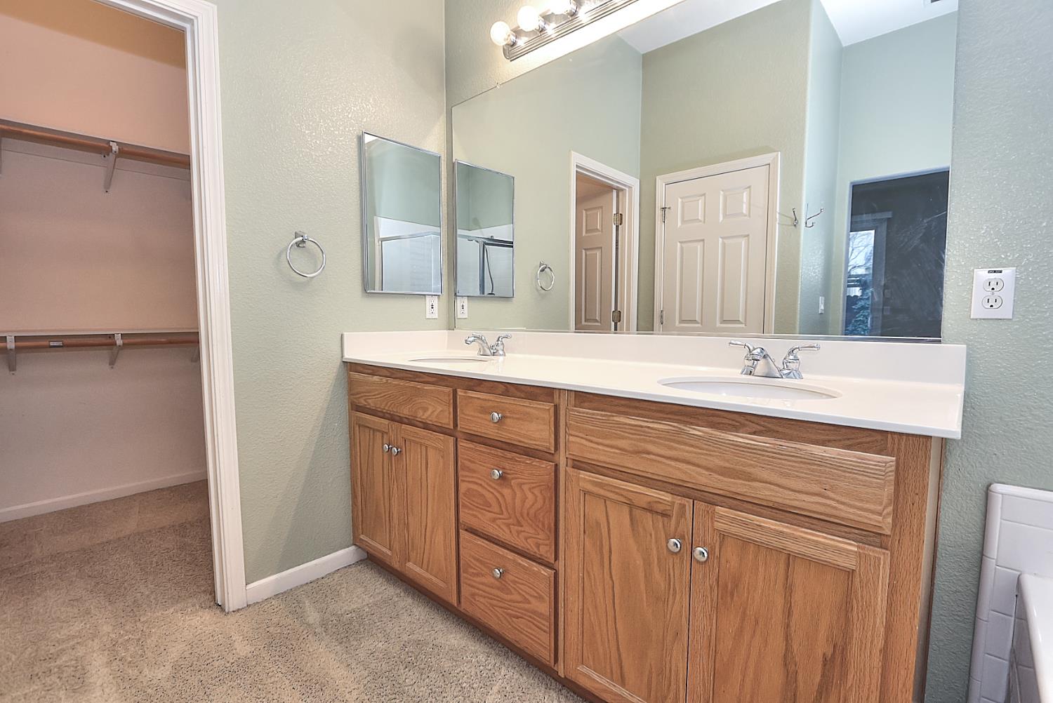 331 Unity Circle Sacramento, CA 95833 - Photo 46 of 77 a spacious bathroom with a granite countertop sink a mirror and a