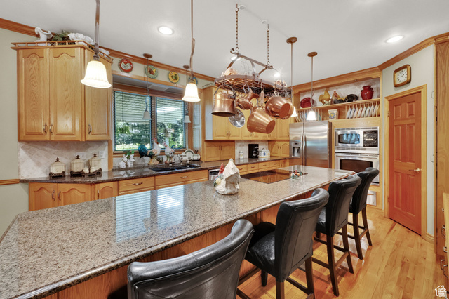 7740 Keswick Road Sandy, UT 84093 - Photo 17 of 74 Kitchen featuring light wood cabinetry, granite countertops, and stainless steel appliances including a double oven and refrigerator