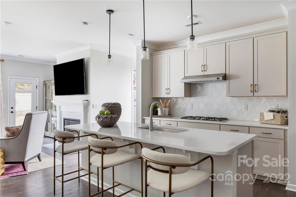 541 Madison Falls Court Fort Mill, SC 29708 - Photo 3 of 25 a kitchen with stainless steel appliances kitchen island granite countertop a dining table chairs and white cabinets