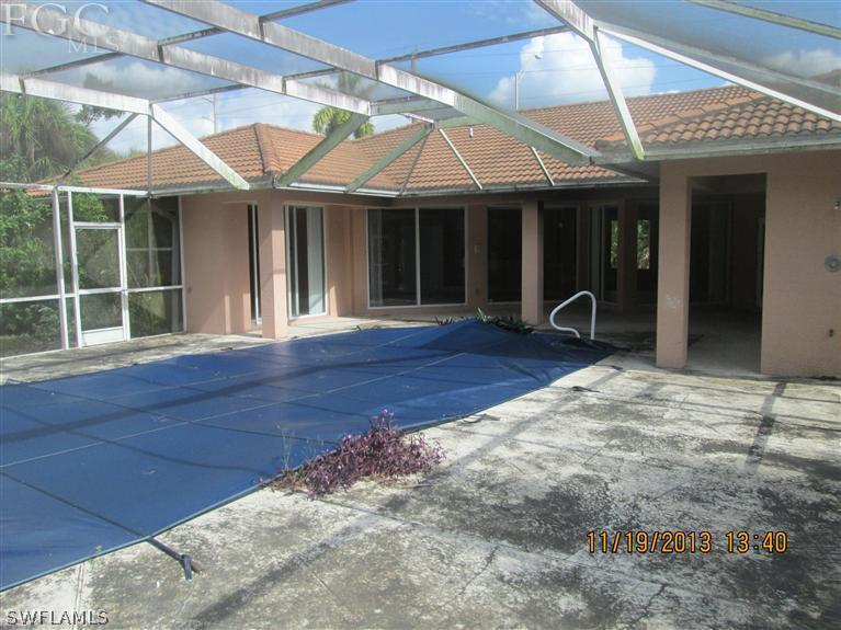 14225 Collier Boulevard Naples, FL 34119 - Photo 3 of 4 a front view of a house with porch and garden