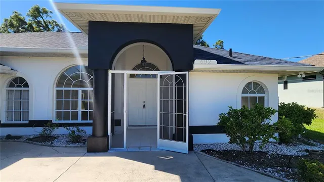 a front view of a house with a garden