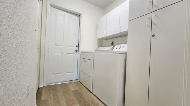 a view of storage and utility room with washer and dryer
