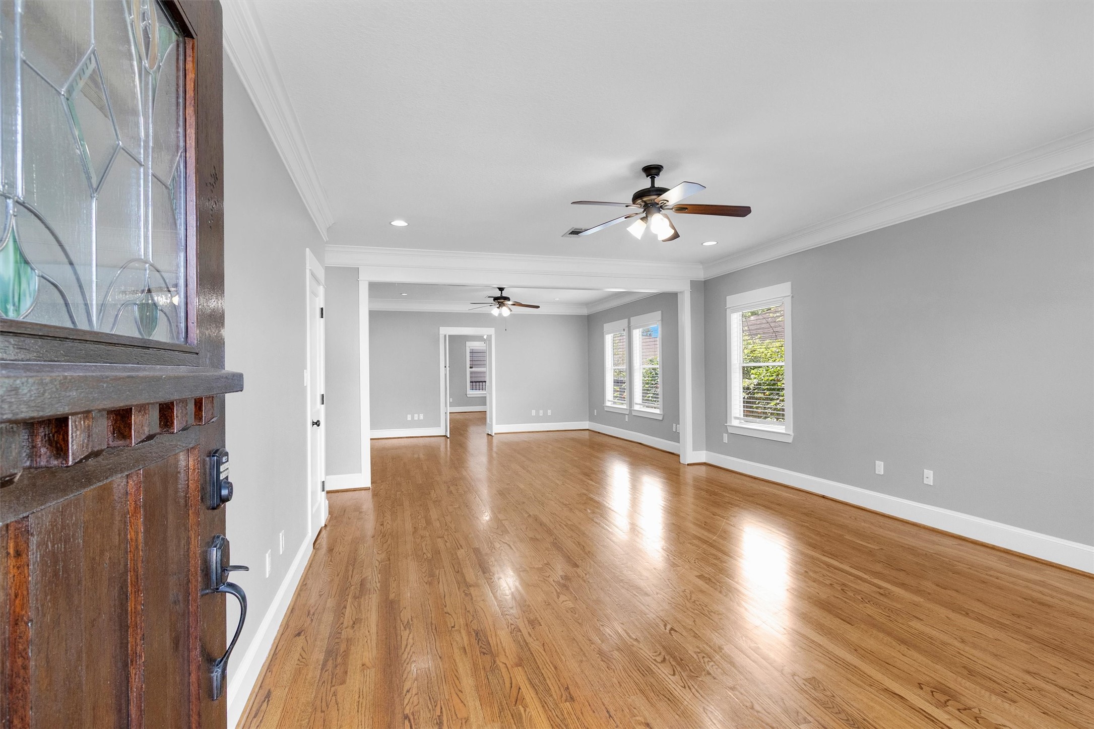 304 Vincent Street Houston, TX 77009 - Photo 5 of 36 a view of an empty room with window and wooden floor