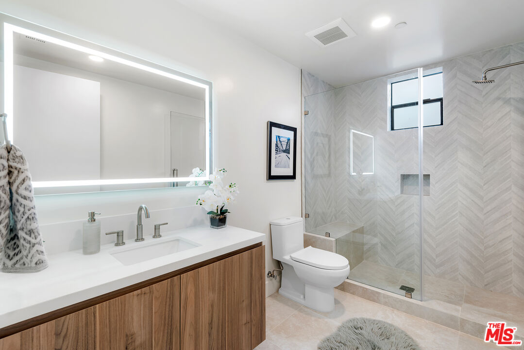 3649 Regal Place, Unit 503 Los Angeles, CA 90068 - Photo 23 of 40 a bathroom with a sink a toilet and shower