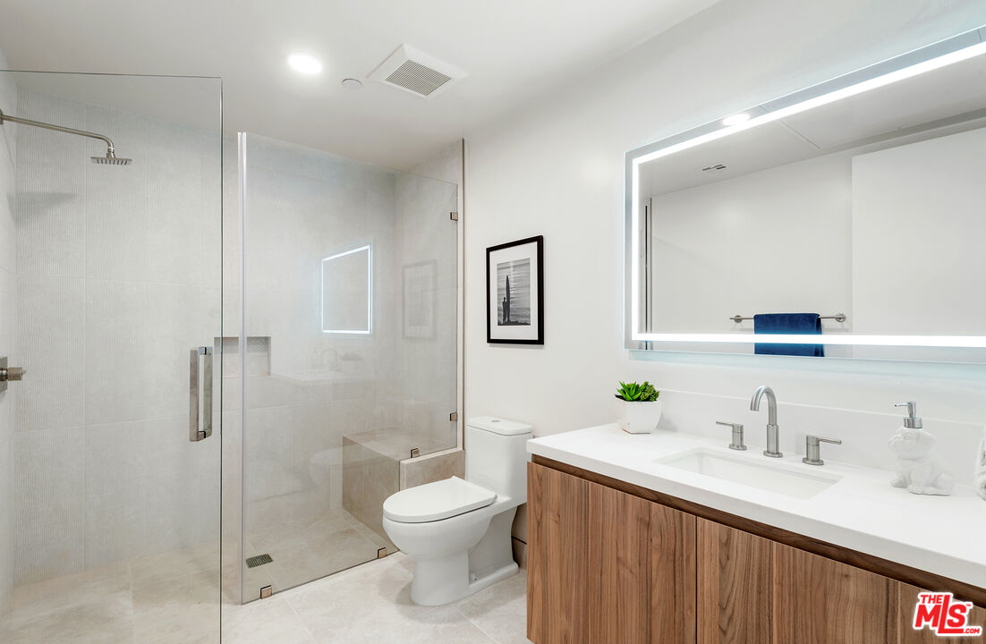 3649 Regal Place, Unit 503 Los Angeles, CA 90068 - Photo 26 of 40 a bathroom with a sink toilet vanity and shower
