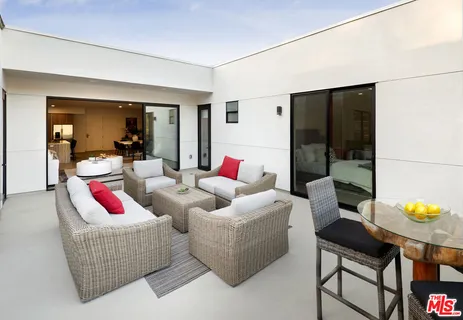 a outdoor space with patio the couches and a potted plant on the table